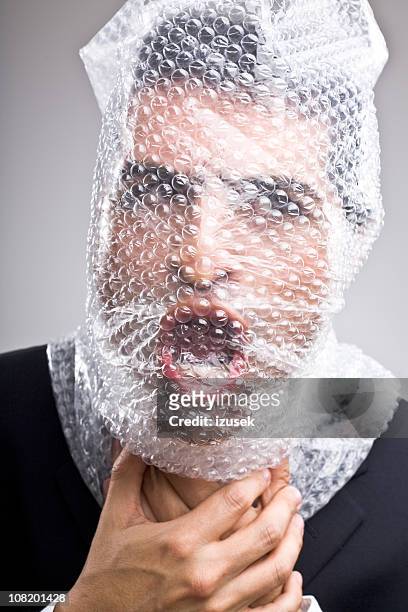 man with bubble wrap around his head - strangling stock pictures, royalty-free photos & images