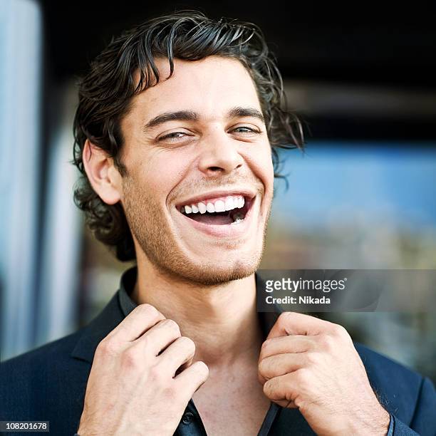 portrait of young man laughing - smug stock pictures, royalty-free photos & images