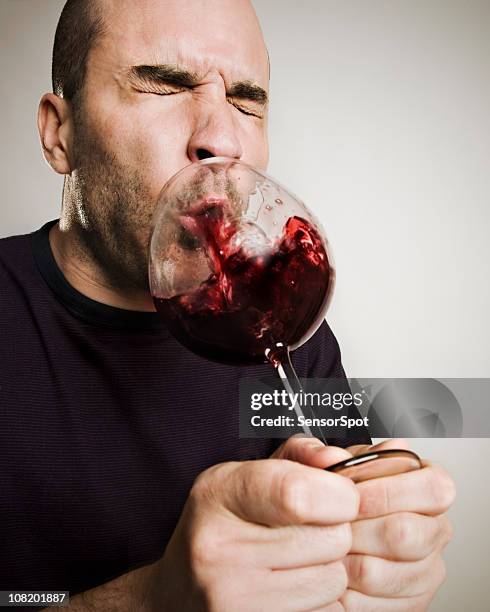 man spitting wine back into glass - spats stock pictures, royalty-free photos & images