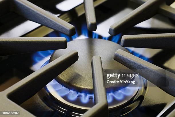 natural gas stove burner appliance with blue flame fire close-up - gasbrander stockfoto's en -beelden