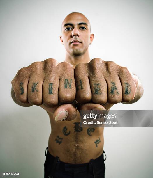 skinhead showing off knuckle tattoo - knuckles stock pictures, royalty-free photos & images