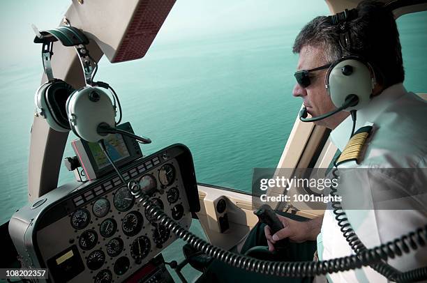 pilot flying airplane with view of ocean from cockpit - inside helicopter stock pictures, royalty-free photos & images