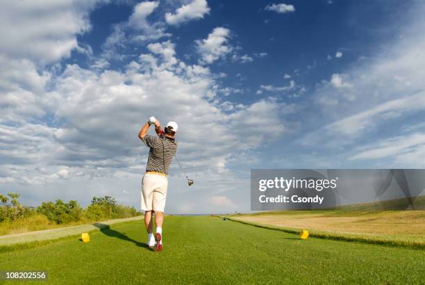 young man playing golf - hitting stock pictures, royalty-free photos & images