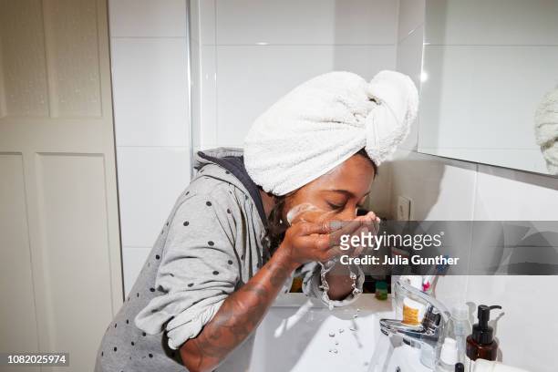 woman washes her face - showus stock pictures, royalty-free photos & images