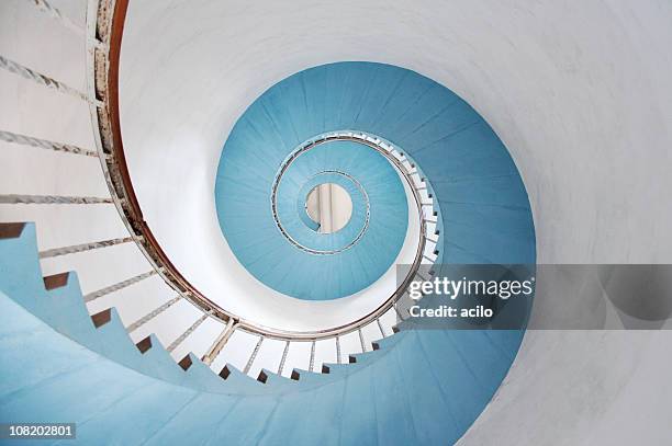 spiral staircase - low angle view of silhouette palm trees against sky stockfoto's en -beelden
