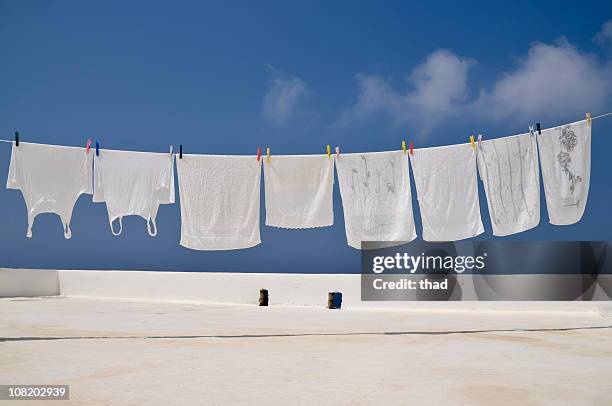 clothesline of bright whites - clothesline stockfoto's en -beelden