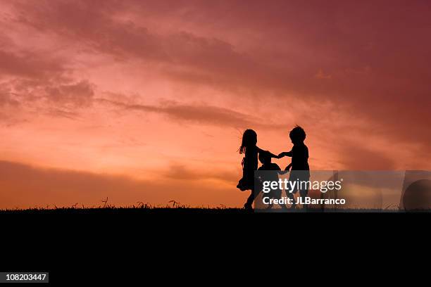 ring around the rosie - three people silhouette stock pictures, royalty-free photos & images