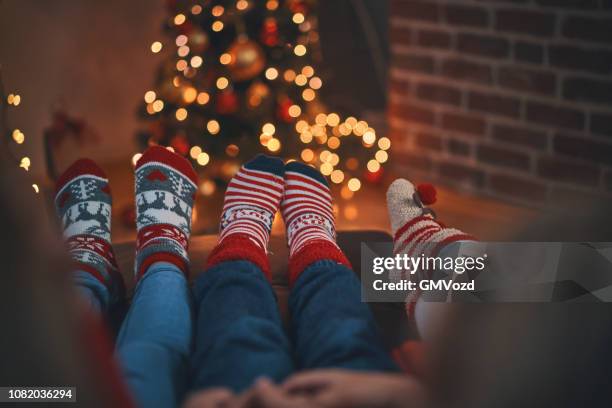 telling stories in cosy christmas atmosphere - fireplace christmas stock pictures, royalty-free photos & images