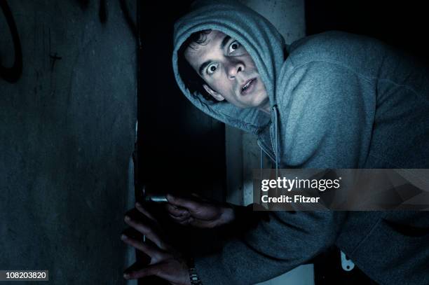 burglar man outside house at night - burglary stock pictures, royalty-free photos & images
