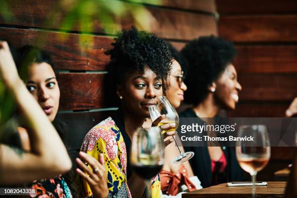 woman enjoying drink with friends at poolside bar - group people thinking stock pictures, royalty-free photos & images