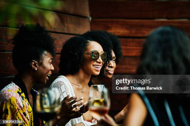 smiling woman hanging out with friends at poolside bar - girls night stock pictures, royalty-free photos & images