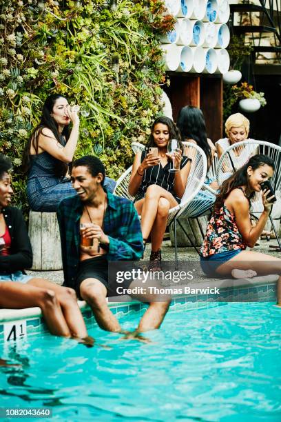 woman taking photo with smart phone during party at hotel pool - friends poolside stock pictures, royalty-free photos & images