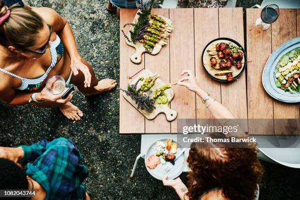 overhead view of friends enjoying appetizers during pool party - indian food bildbanksfoton och bilder