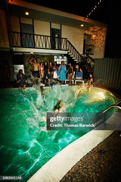 woman in dress falling into hotel pool during party - pool party night stock pictures, royalty-free photos & images