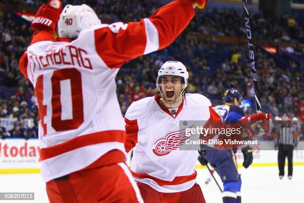 Patrick Eaves of the Detroit Red Wings celebrates his goal with his teammate Henrik Zetterberg against the St. Louis Blues at the Scottrade Center on...