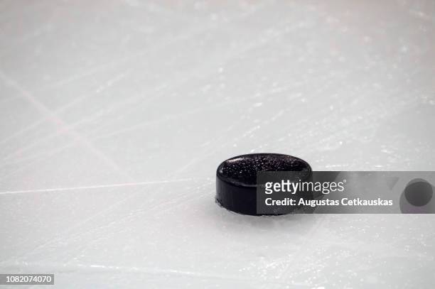 close-up of hockey puck on ice rink - hockey puck stock pictures, royalty-free photos & images