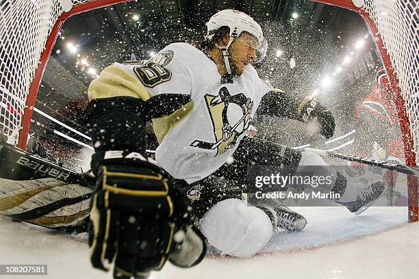 Kris Letang of the Pittsburgh Penguins goes sliding into the net during the game against of the New Jersey Devils at the Prudential Center on January...