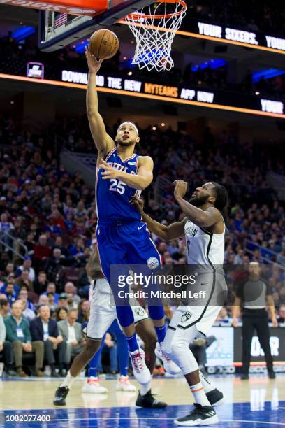 Ben Simmons of the Philadelphia 76ers shoots the ball against Ed Davis and DeMarre Carroll of the Brooklyn Nets at the Wells Fargo Center on December...