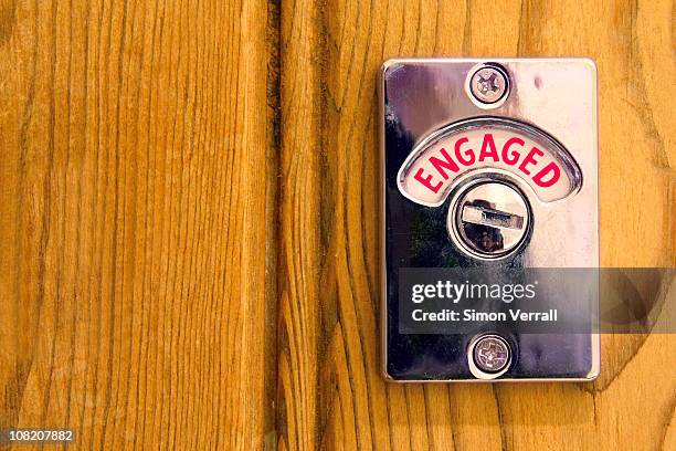 toilet engaged door sign - bathroom stall door interior stock pictures, royalty-free photos & images