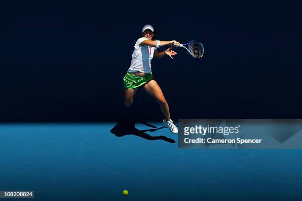 Justine Henin of Belgium plays a forehand in her third round match against Svetlana Kuznetsova of Russia during day five of the 2011 Australian Open...
