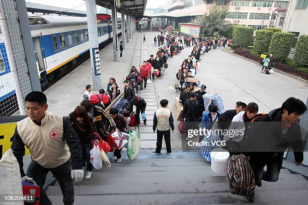 More than 600 migrant workers wait in line to take the first special train home at Dongguan East Railway Station on January 20, 2011 in Dongguan,...