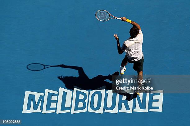 Roger Federer of Switzerland plays a forehand in his third round match against Xavier Malisse of Belgium during day five of the 2011 Australian Open...
