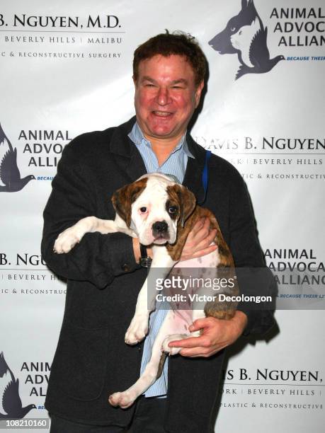 Actor Robert Wuhl holds Oliver the English bulldog as he arrives at "Barks & Botox" Fundraiser Benefitting The Animal Advocates Alliance on January...