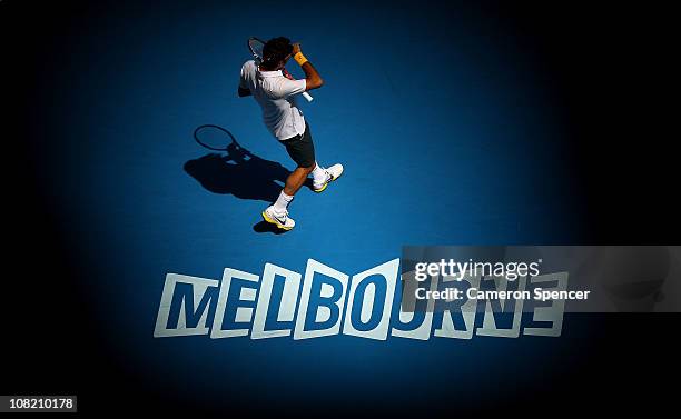 Roger Federer of Switzerland walks on court in his third round match against Xavier Malisse of Belgium during day five of the 2011 Australian Open at...