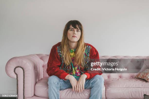 portrait of woman on her sofa - transgender stock-fotos und bilder