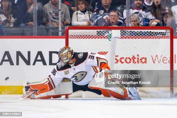 Goaltender John Gibson of the Anaheim Ducks does the splits the in crease as the puck goes wide during first period action against the Winnipeg Jets...