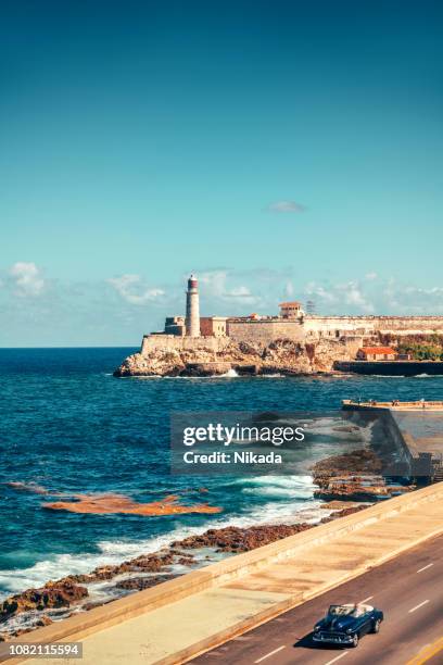 classic american car on the malecon in havana, cuba - havana stock pictures, royalty-free photos & images