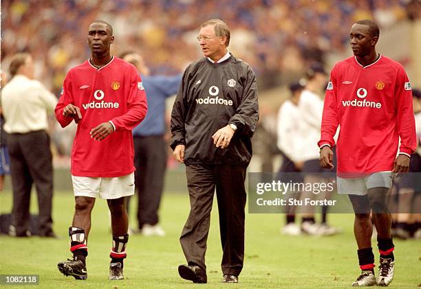 Andy Cole , Manchester United manager Alex Ferguson and Dwight Yorke of Manchester United walk off after the Charity Shield match against Chelsea...