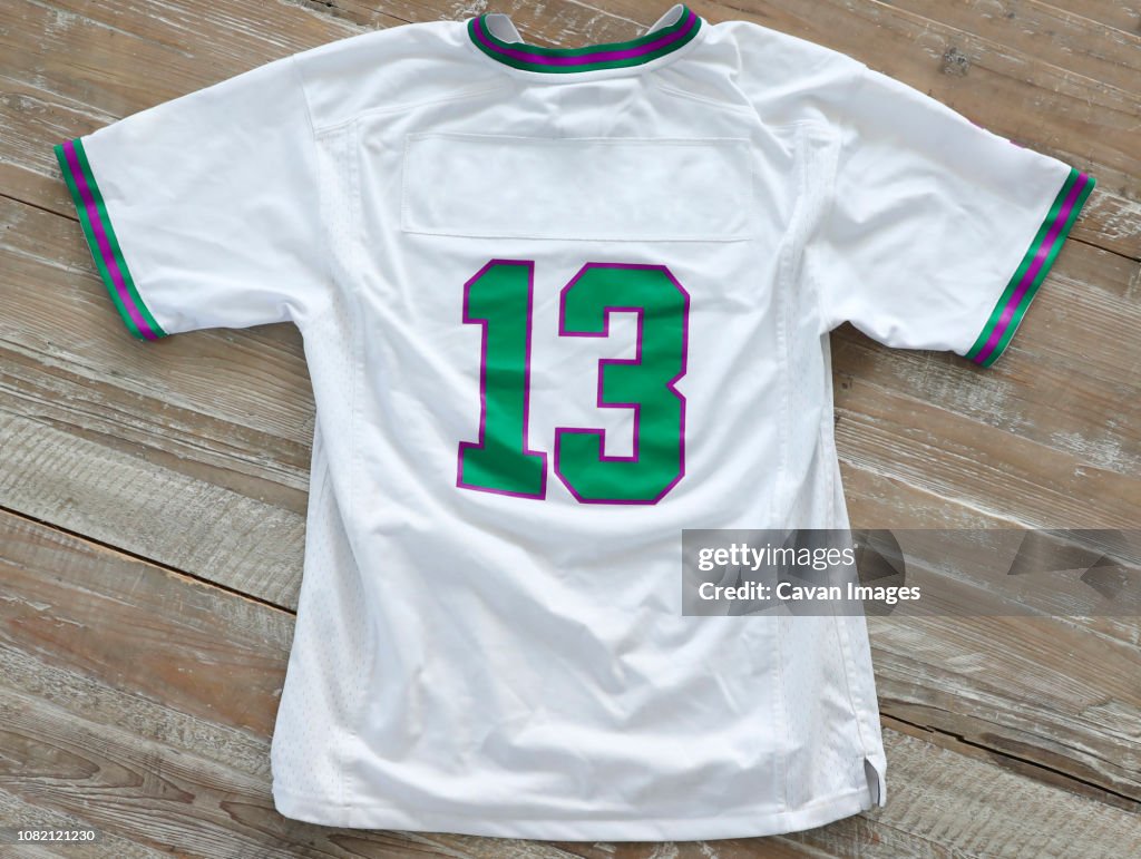 High angle view of t-shirt with number 13 on wooden table