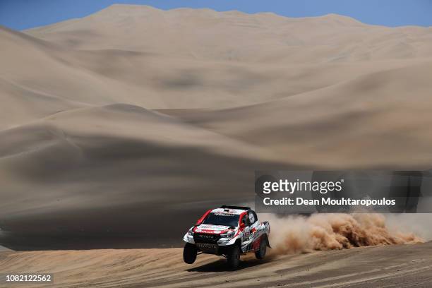 Toyota Gazoo Racing Sa no. 301 TOYOTA HILUX car driven by Nasser Al-Attiyah of Qatar and Matthieu Baumel of France compete in the desert on the sand...