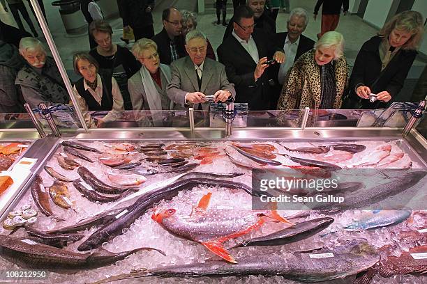 Visitors crowd a display of fresh fish at a stand at the 2011 Gruene Woche international agricultural trade fair at Messe Berlin on January 21, 2011...