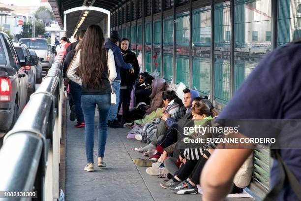 Asylum seekers await processing on the International Bridge on the US/Mexico border in Laredo, Texas, on January 13, 2019.