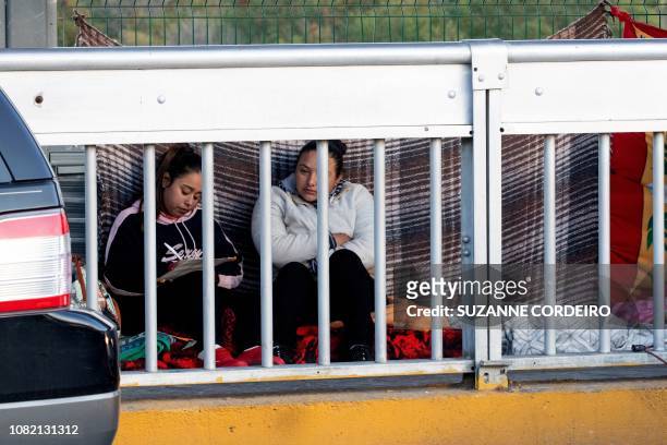 Asylum seekers await processing on the International Bridge on the US/Mexico border in Laredo, Texas, on January 13, 2019.