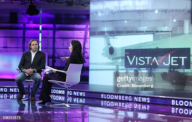 Thomas Flohr, founder and chairman of VistaJet Holding SA, left, pauses during a television interview in London, U.K., on Friday, Jan. 21, 2010....