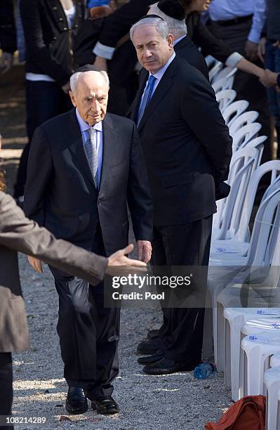 Israel's Prime Minister Benjamin Netanyahu watches Israeli President Shimon Peres as he arrives for the funeral ceremony of his late wife Sonia on...