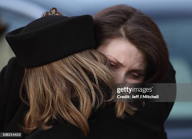 Mourners embrace as they attend the funeral of Scottish singer songwriter Gerry Rafferty at St Mirren Cathedral on January 21, 2011 in Paisley,...