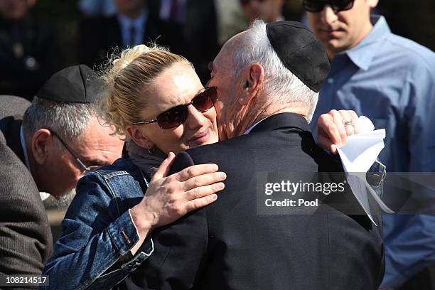 Israeli President Shimon Peres is comforted by his granddaughter Mika Almog during his late wife Sonia's funeral ceremony on January 21, 2011 in Ben...