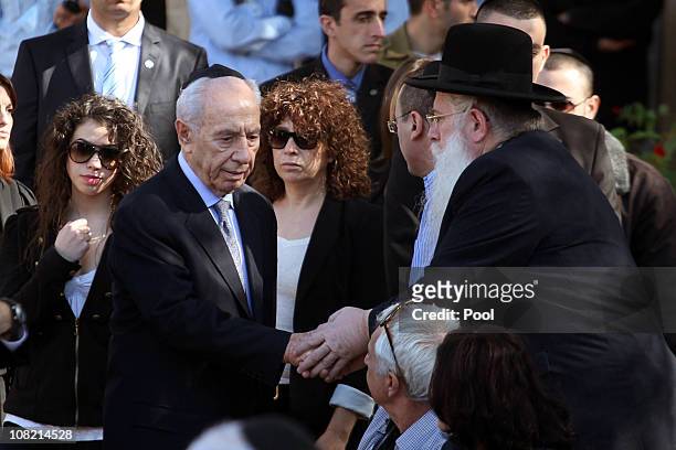 Israeli President Shimon Peres is comforted by MP Meir Porush during the funeral service of his late wife Sonia during her funeral ceremony on...
