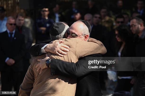 Yoni and Nechemia Peres, sons of Israeli President Shimon Peres, comfort each other during their mother Sonia's funeral ceremony on January 21, 2011...