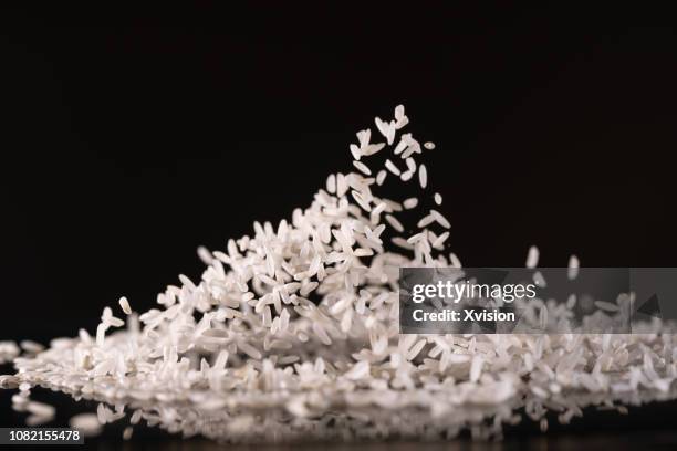 rice dance with black background studio shot with high speed syn. - rice stock pictures, royalty-free photos & images