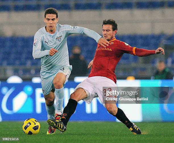 Anderson Hernanes of Lazio is tackled by Matteo Brocchi of Roma during the Tim Cup match between Roma and Lazio at Stadio Olimpico on January 19,...