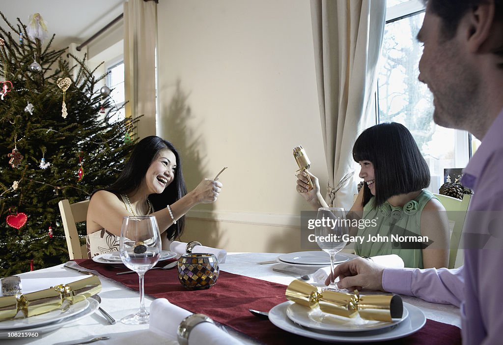 Family pulling christmas crackers