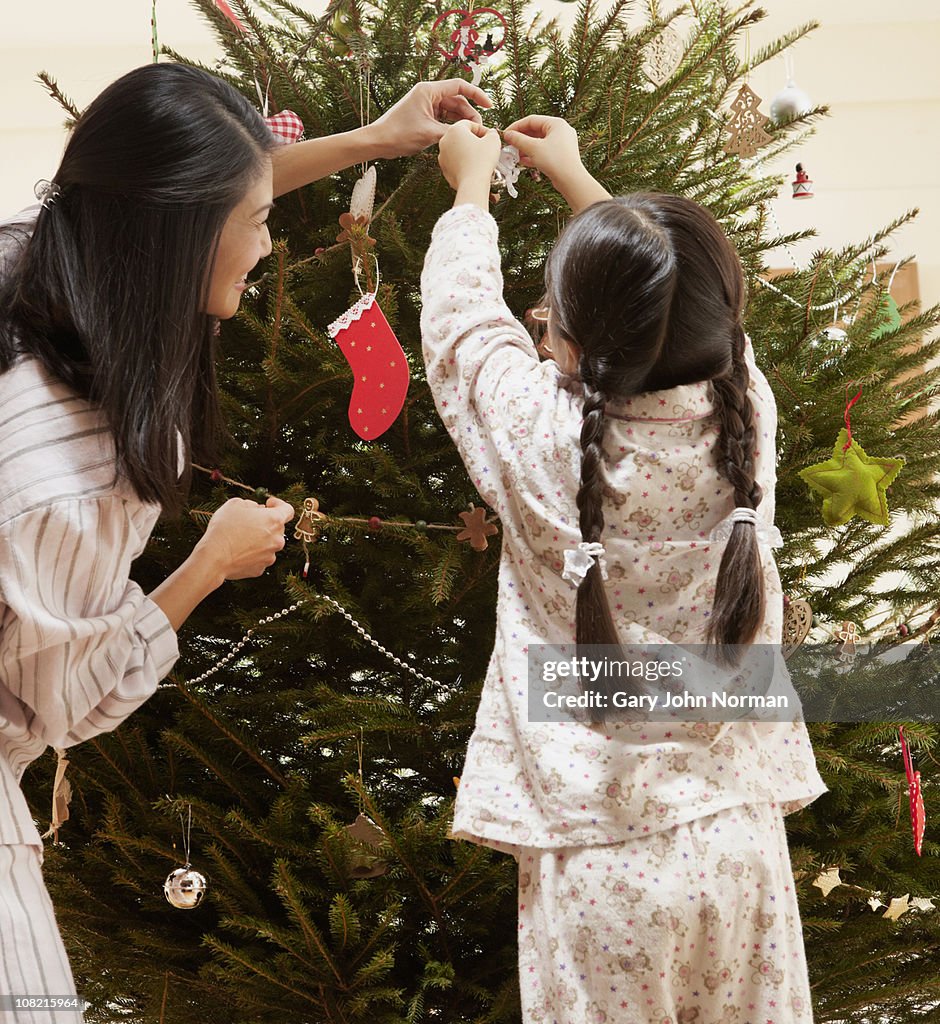 Mother & daughter place christmas decorations