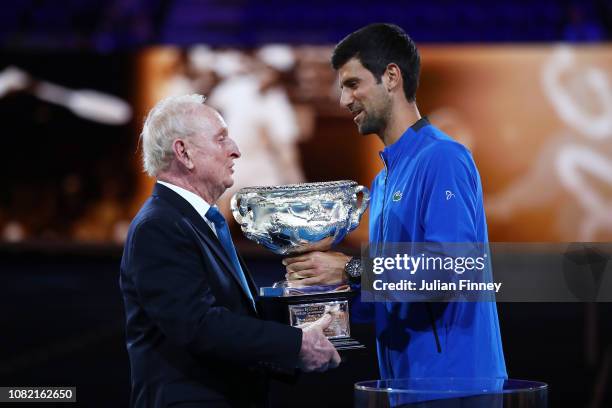 Novak Djokovic presents Rod Laver with the Norman Brookes Challenge Cup during the 50th anniversary celebration for Australian Open and Rod Laver's...