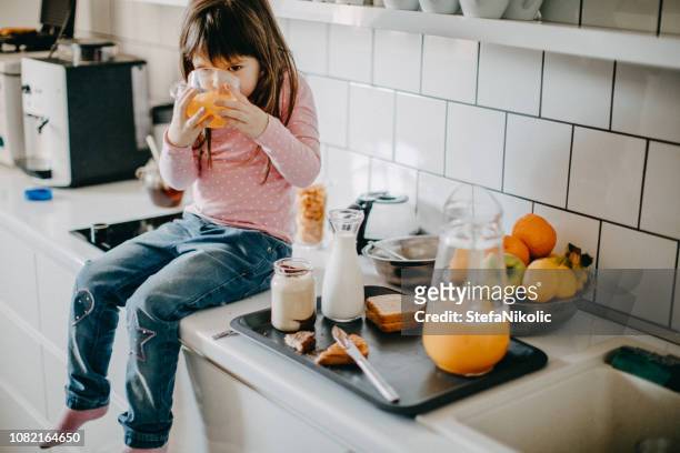 girl having breakfast in kitchen - cloche stock pictures, royalty-free photos & images