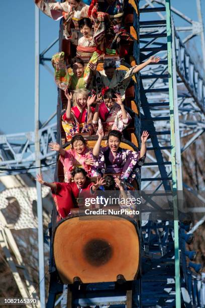 Japanese women wearing kimonos ride a roller coaster during their Coming of Age Day celebration ceremony at Toshimaen amusement park in Tokyo, Japan...